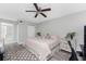 Serene bedroom with neutral tones, ceiling fan, and access to the ensuite bathroom creating a relaxing retreat at 1401 S Mccall Rd # A 108, Englewood, FL 34223