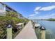 Community dock with boat and beautiful waterfront views under a sunny sky at 1401 S Mccall Rd # A 108, Englewood, FL 34223
