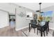 Inviting dining area with modern table and chairs, open to the kitchen and living space at 1401 S Mccall Rd # A 108, Englewood, FL 34223
