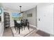 Cozy dining area featuring a glass-top table, modern chairs, and tasteful decor at 1401 S Mccall Rd # A 108, Englewood, FL 34223