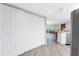 Hallway with wood-look floors and view to living area at 1401 S Mccall Rd # A 108, Englewood, FL 34223