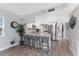 Open kitchen concept with breakfast bar, white cabinetry, granite countertops, and stainless steel appliances at 1401 S Mccall Rd # A 108, Englewood, FL 34223
