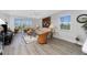 Bright living room showcasing a sliding glass door to a balcony and wicker furniture, filled with natural light at 1401 S Mccall Rd # A 108, Englewood, FL 34223