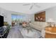Bright living room with sliding glass doors to balcony, comfortable seating, and stylish decor at 1401 S Mccall Rd # A 108, Englewood, FL 34223