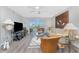Bright living room with sliding doors to balcony, comfortable seating, and stylish decor at 1401 S Mccall Rd # A 108, Englewood, FL 34223