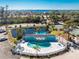 Aerial view of the community pool with a sun shelter, parking, and surrounding water views at 1401 S Mccall Rd # A 108, Englewood, FL 34223