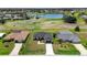 Aerial view of a one story home located on a golf course near a pond and other homes at 166 Bunker Rd, Rotonda West, FL 33947