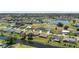 Aerial view of a one story home located in a neighborhood with canal access at 166 Bunker Rd, Rotonda West, FL 33947