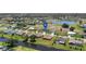 Aerial view of a one story home located in a neighborhood with canal access at 166 Bunker Rd, Rotonda West, FL 33947