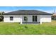 Enjoy the backyard featuring a covered patio, perfect for relaxation and outdoor enjoyment at 166 Bunker Rd, Rotonda West, FL 33947