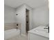 Elegant bathroom with dual vanities, quartz countertops, a soaking tub, and a tiled shower at 166 Bunker Rd, Rotonda West, FL 33947