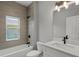 Bathroom with a modern vanity, decorative lights, and tiled shower at 166 Bunker Rd, Rotonda West, FL 33947