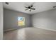 A bright and spacious bedroom with modern tile flooring, a ceiling fan, and a large window at 166 Bunker Rd, Rotonda West, FL 33947