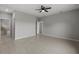 Spacious bedroom featuring modern tile flooring, a ceiling fan, and access to the ensuite bathroom at 166 Bunker Rd, Rotonda West, FL 33947