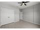 Bright bedroom featuring a ceiling fan, closet, and wood-look tile floors at 166 Bunker Rd, Rotonda West, FL 33947