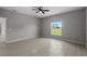 Spacious bedroom featuring modern tile flooring, a ceiling fan, and a large window with a view at 166 Bunker Rd, Rotonda West, FL 33947