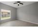 Bedroom featuring a ceiling fan, bright window, and wood-look tile floors at 166 Bunker Rd, Rotonda West, FL 33947