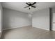 A bright and spacious bedroom with modern tile flooring and a ceiling fan at 166 Bunker Rd, Rotonda West, FL 33947
