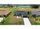 Beautiful one-story home overlooking a golf course with a lush green lawn and a paved driveway at 166 Bunker Rd, Rotonda West, FL 33947