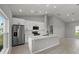 Modern kitchen with white cabinets, stainless appliances, and island with sink, ideal for cooking and gathering at 166 Bunker Rd, Rotonda West, FL 33947
