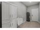 Laundry room featuring extra cabinets, a sink, and a water heater at 166 Bunker Rd, Rotonda West, FL 33947