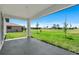 Covered patio overlooking green lawn and community landscaping at 166 Bunker Rd, Rotonda West, FL 33947
