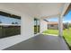 Spacious covered patio offering views of the manicured backyard and landscaping at 166 Bunker Rd, Rotonda West, FL 33947