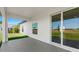 Covered patio with sliding glass door leading to the backyard and lawn at 166 Bunker Rd, Rotonda West, FL 33947