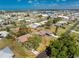 Birds eye view of a home featuring a pool in a residential neighborhood with abundant greenery at 1670 Faust Dr, Englewood, FL 34224
