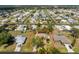 Aerial view of a home with a private pool in a densely populated residential area with mature landscaping at 1670 Faust Dr, Englewood, FL 34224