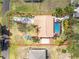 Aerial photograph showcasing a residence featuring a pool, landscaping, and a spacious driveway at 1670 Faust Dr, Englewood, FL 34224