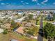 Aerial view of a residential home with a pool, nestled among green trees in a developed neighborhood at 1670 Faust Dr, Englewood, FL 34224