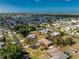 An aerial perspective of a home featuring a pool, nestled in a residential area close to a body of water at 1670 Faust Dr, Englewood, FL 34224