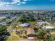 Aerial view capturing a residential house with a pool and lush landscaping in a suburban neighborhood at 1670 Faust Dr, Englewood, FL 34224