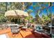 Charming screened patio with dining set and lush garden featuring a rock waterfall at 1670 Faust Dr, Englewood, FL 34224
