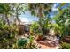 Tropical oasis backyard featuring brick patio, lush greenery, and a screened pool area, perfect for relaxation at 1670 Faust Dr, Englewood, FL 34224