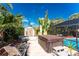 Tropical backyard featuring a pool, spa, patio, shed, and lounge area perfect for relaxing and entertaining at 1670 Faust Dr, Englewood, FL 34224