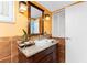 Bathroom featuring earth tone ceramic tile and a vanity with dark wood cabinetry at 1670 Faust Dr, Englewood, FL 34224