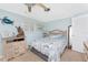 Bright bedroom featuring plantation shutters and wood-look tile flooring at 1670 Faust Dr, Englewood, FL 34224
