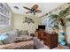 Bright bonus room with a ceiling fan, comfortable seating, and desk at 1670 Faust Dr, Englewood, FL 34224