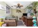 Bright bonus room with a ceiling fan, comfortable seating, and desk at 1670 Faust Dr, Englewood, FL 34224
