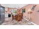 Elegant dining area with a chandelier, wicker chairs, and views into the kitchen at 1670 Faust Dr, Englewood, FL 34224
