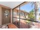 View of the front door with a decorative wreath, leading to a charming screened-in porch at 1670 Faust Dr, Englewood, FL 34224