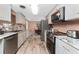 Bright kitchen with stainless steel appliances and granite countertops, seamlessly flowing into the dining area at 1670 Faust Dr, Englewood, FL 34224