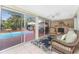 Relaxing lanai with stone fireplace, tile floors, and screened-in views of the pool at 1670 Faust Dr, Englewood, FL 34224