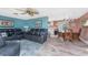 Inviting living room featuring comfortable leather seating, ceiling fan, and an adjacent dining area at 1670 Faust Dr, Englewood, FL 34224