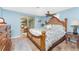Bright main bedroom with a decorative ceiling fan and sliding door access to the patio at 1670 Faust Dr, Englewood, FL 34224