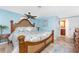Spacious main bedroom featuring a ceiling fan, wood-look flooring, and en-suite bathroom access at 1670 Faust Dr, Englewood, FL 34224