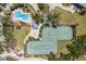 Overhead view of a community featuring a pool, tennis courts, green spaces, and winding walking paths at 17 Seawatch Dr, Boca Grande, FL 33921
