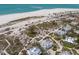 Overhead view showcasing waterfront homes by the beach with private boardwalks surrounded by lush vegetation at 17 Seawatch Dr, Boca Grande, FL 33921